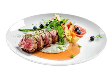Foto auf Acrylglas Delicious medium rare meat steak with sauce and salad on a plate. Healthy food made of meat fillet and fresh herbs isolated on a white background. © Maxim Khytra