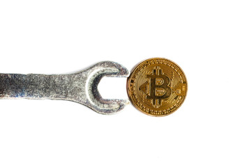 Gears and cogs close up and bitcoin coin white; background; wrench; isolated