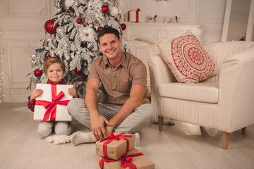 Father with son at home on Christmas evening