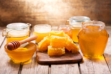 various types of honey in glass jars