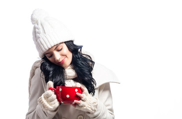 Young woman in winter clothes drinking coffee