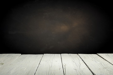 Old wood table top with smoke in the dark background.