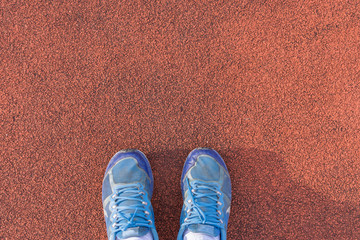 Blue shoes on the orange background.