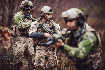 Fototapeta premium soldiers or private military contractors aiming with rifle. war, army, weapon, technology and people concept.