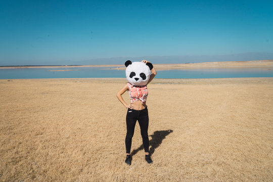 Woman with panda hat posing on nature