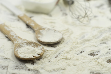 Close up of baking utensils with flour spread on the table. Selective focus applied.