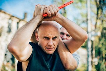 Self defense disarming technique against threat and knife attack