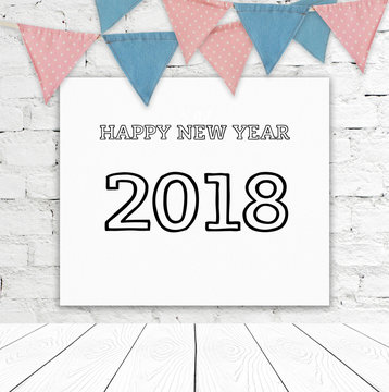 Happy new year 2018 on whiteboard hanging on white brick wall and part bunting flags background, new year greeting card