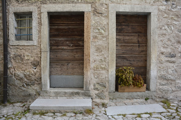 Old wooden doors in disused buildings the historic hill village of Erto in Friuli Venezia Giulia,...