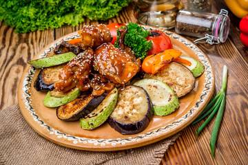 Roasted rabbit legs garnished with potato and broccoli
