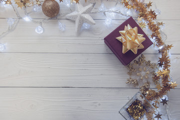 Christmas wreath on wooden background, roses and balls, happy sunny day