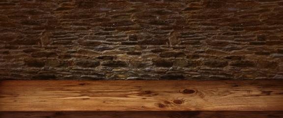 Rustic wooden table with stone wall