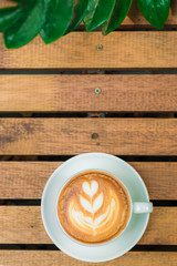 Latte art coffee whit cup on wood table