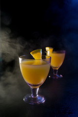 orange drink on a black background.