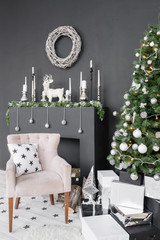 Christmas postcard template. Chimney place with candles. Copy space, black background.