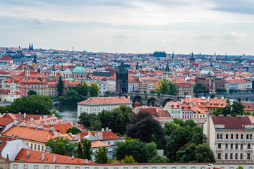 Fototapeta na wymiar Charles bridge, St. Nicolas church and roofs of Prague