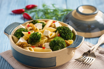 Pasta penne with broccoli, feta cheese and pepper.