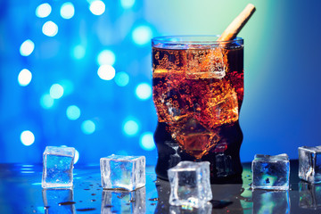 Cola in drinking glass with ice cube sweet sparkling carbonated drink beverage fast food with big calorie