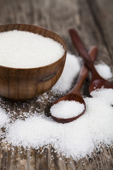 Bowl with sugar and a wooden spoon