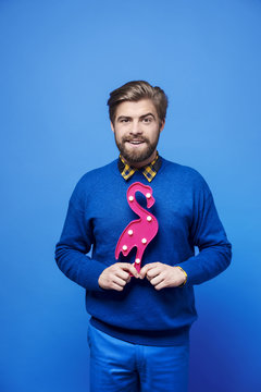 Man with artificial flamingo at studio shot
