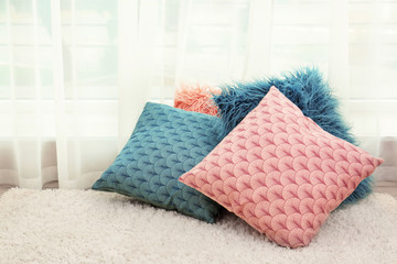 Colorful pillows on floor indoors