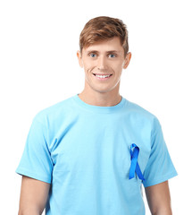 Young man wearing t-shirt with blue ribbon on white background. Prostate cancer awareness concept