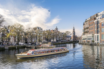 Fototapeta na wymiar Panorama of Amsterdam with touristic boat, The Netherlands