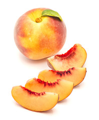 Sliced one whole peach with a green leaf and four slices, isolated on white background.