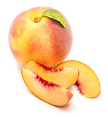 One whole peach and three slices isolated on white background.