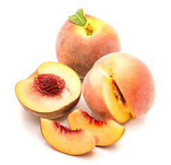 Peaches, one whole, one half and cut open, two slices, isolated on white background.