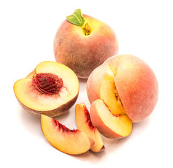 Peaches, one whole, one half and cut open, three slices, isolated on white background.