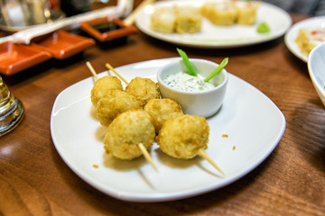 Cheese balls on skewers, with sauce