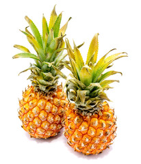 Two whole pineapples isolated on white background.