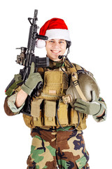 soldier with rifle wearing Santa claus cup and holding cardbox isolated on white background