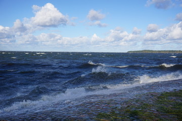 Waves in the ocean with clouds
