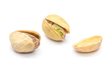 Two whole open pistachio nuts, one shell half isolated on white background.