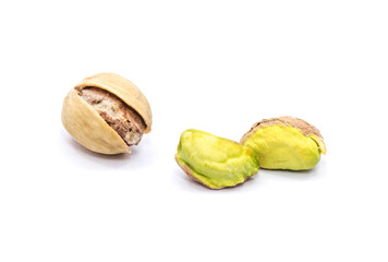 One open pistachio nuts, two without shells, isolated on white background.