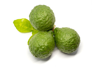 close up group of fresh bergamot with green leaves isolated on white background. benefits of bergamot for beauty and health concept