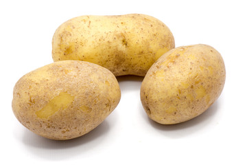 Three whole potatoes isolated on white background.