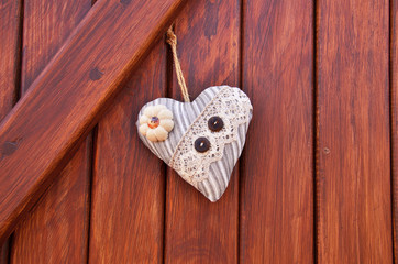 textile heart on the wood wall (Valentine's day)