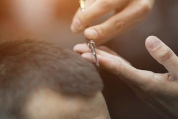 Obraz premium Young handsome man in barbershop