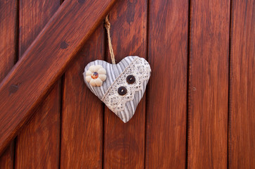 textile heart on the wood wall (Valentine's day)