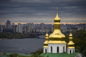Fototapeta na wymiar Church domes on the background of the city