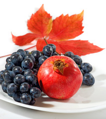 grapes, pomegranate and autumn leaf closeup