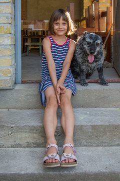 The girl is playing with a dog