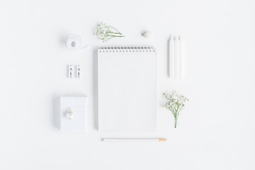 Christmas composition. Notebook, gypsophila flowers on white background. Christmas, winter, new year concept. Flat lay, top view, copy space
