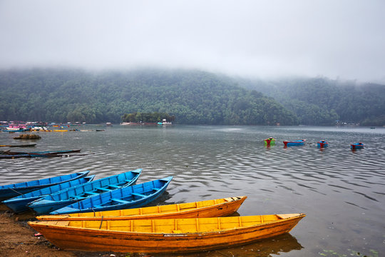 Colored boats on the water on a lake in Nepal