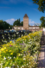 Fototapeta na wymiar Flowers decoration with ponts Couverts in Strasbourg