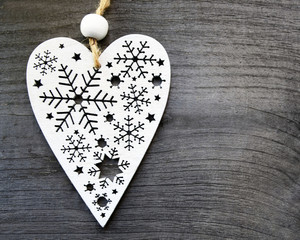 Christmas decoration.Decorative white christmas heart on old wooden background.