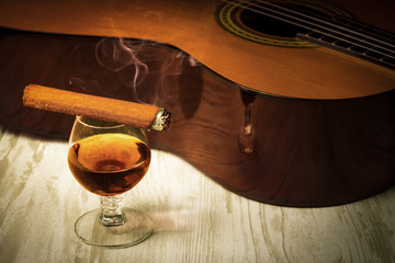 Concept behind the music the guitar, the glass of cognac and the cigar